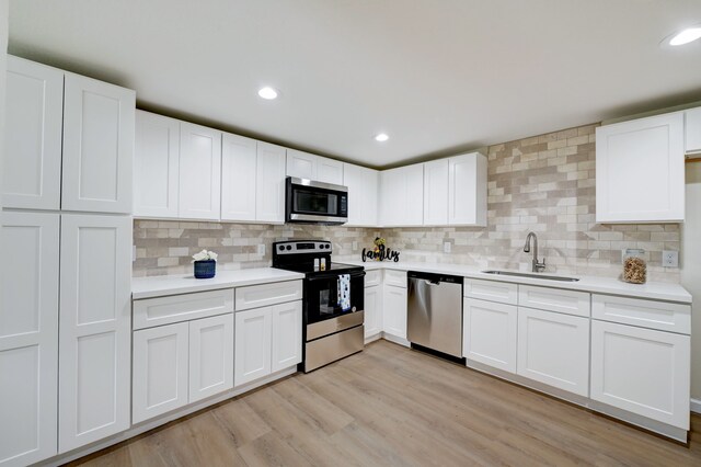 104 18th Ave N, Texas City, TX 77590 - kitchen featuring appliances with stainless steel finishes, a sink, light countertops, decorative backsplash, and recessed lighting