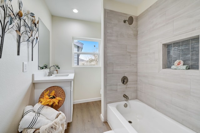 104 18th Ave N, Texas City, TX 77590 - bathroom with vanity,  shower combination, wood finished floors, baseboards, and recessed lighting
