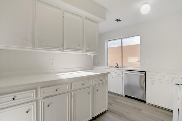 8718 Maplecrest Dr, Houston, TX 77099 - kitchen featuring dishwasher, white cabinetry, light countertops, and light wood-style flooring