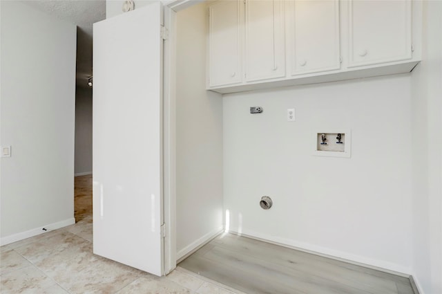8718 Maplecrest Dr, Houston, TX 77099 - washroom with hookup for a washing machine, electric dryer hookup, baseboards, and cabinet space