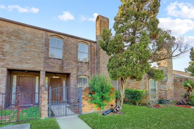 8718 Maplecrest Dr, Houston, TX 77099 - view of front of house featuring a gate, brick siding, and a chimney