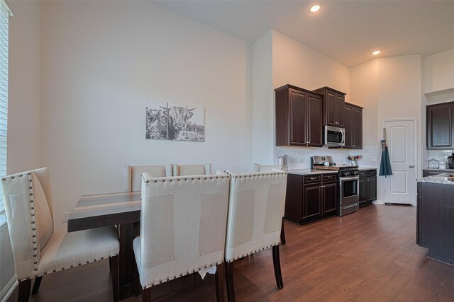 308 Morning Dove Trl, Sealy, TX 77474 - kitchen featuring stainless steel appliances, dark wood-style flooring, dark brown cabinetry, backsplash, and recessed lighting