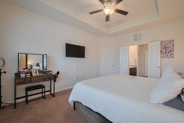 308 Morning Dove Trl, Sealy, TX 77474 - bedroom featuring carpet flooring, a tray ceiling, baseboards, and ceiling fan