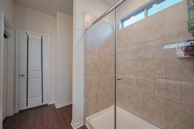 308 Morning Dove Trl, Sealy, TX 77474 - full bathroom featuring tiled shower, wood finished floors, and baseboards