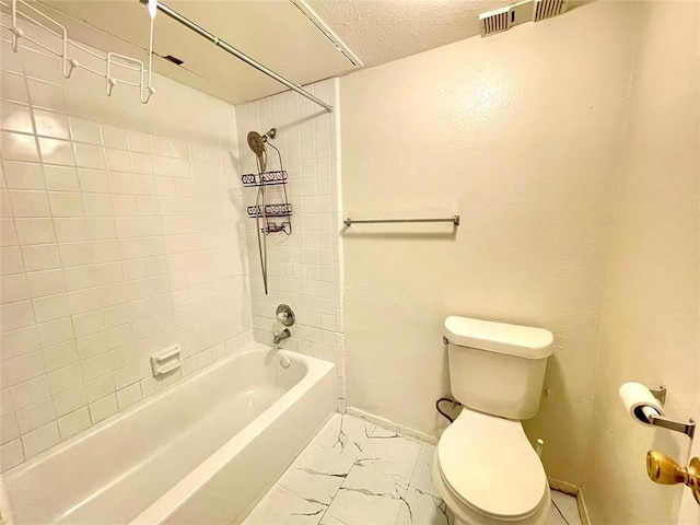 2100 Wilcrest Dr Unit 123, Houston, TX 77042 - bathroom with toilet, baseboards, shower / bath combination, a textured ceiling, and marble look tiles