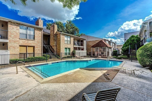 2100 Wilcrest Dr Unit 123, Houston, TX 77042 - community pool featuring a patio area, stairway, and a gazebo