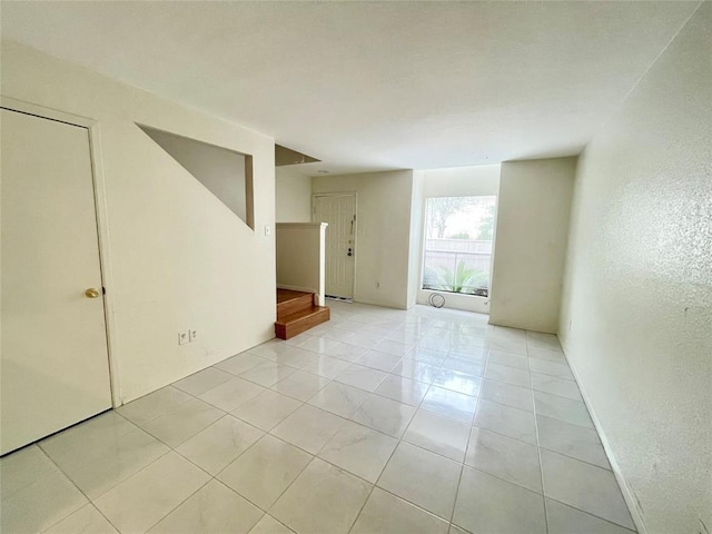 2100 Wilcrest Dr Unit 123, Houston, TX 77042 - spare room featuring stairs and light tile patterned floors
