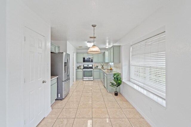 13911 Fraser Lake Ln, Houston, TX 77083 - kitchen featuring appliances with stainless steel finishes, green cabinets, light countertops, tasteful backsplash, and light tile patterned flooring