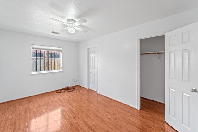 13911 Fraser Lake Ln, Houston, TX 77083 - unfurnished bedroom featuring light wood-style flooring, a ceiling fan, a spacious closet, baseboards, and a closet