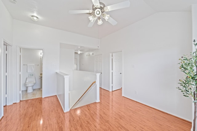 13911 Fraser Lake Ln, Houston, TX 77083 - unfurnished bedroom featuring light wood-style flooring, ensuite bath, and vaulted ceiling