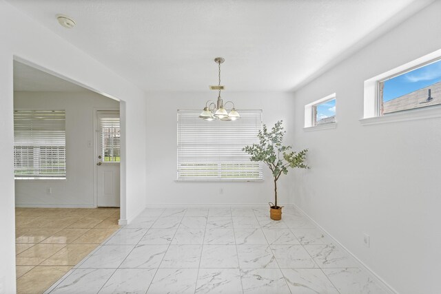 13911 Fraser Lake Ln, Houston, TX 77083 - unfurnished dining area with marble finish floors, a chandelier, and baseboards