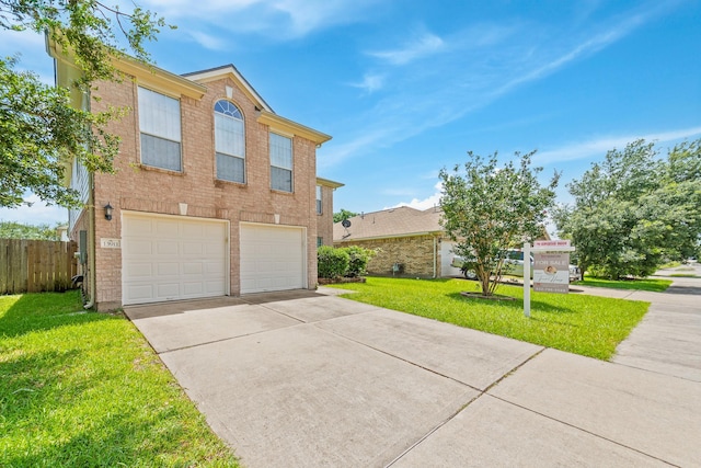 13911 Fraser Lake Ln, Houston, TX 77083 - traditional-style home featuring an attached garage, driveway, and brick siding