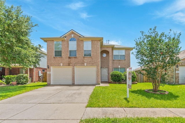 13911 Fraser Lake Ln, Houston, TX 77083 - traditional-style house featuring driveway, an attached garage, a front lawn, and brick siding