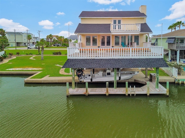 1327 Tiki Dr, Tiki Island, TX 77554 - back of property featuring a balcony, a lawn, a chimney, and a deck with water view