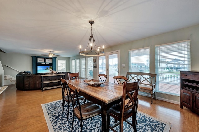 1327 Tiki Dr, Tiki Island, TX 77554 - dining room featuring plenty of natural light, stairway, a chandelier, and light wood-style floors