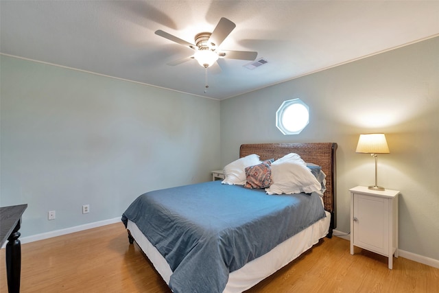 1327 Tiki Dr, Tiki Island, TX 77554 - bedroom featuring light wood-style flooring, a ceiling fan, and baseboards
