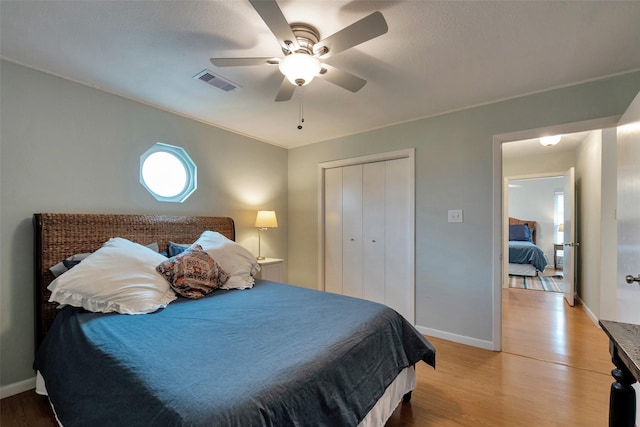 1327 Tiki Dr, Tiki Island, TX 77554 - bedroom featuring light wood-type flooring, baseboards, a closet, and a ceiling fan