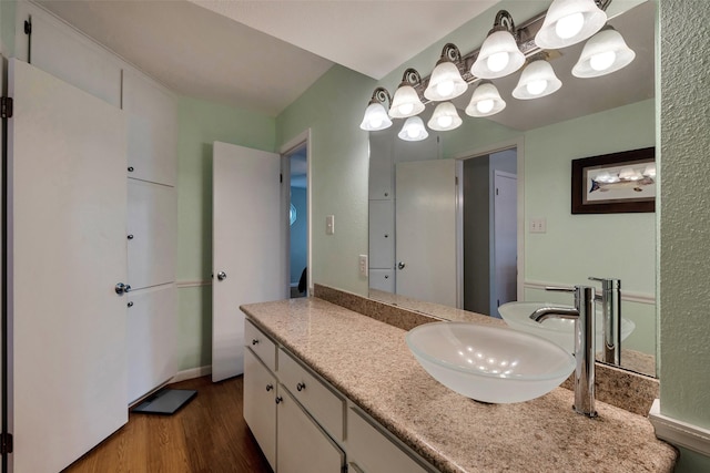 1327 Tiki Dr, Tiki Island, TX 77554 - bathroom featuring wood finished floors, vanity, and a chandelier