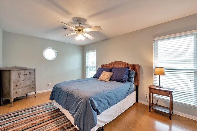 1327 Tiki Dr, Tiki Island, TX 77554 - bedroom featuring baseboards, wood finished floors, and ceiling fan