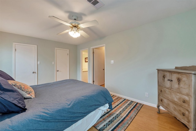 1327 Tiki Dr, Tiki Island, TX 77554 - bedroom featuring baseboards, light wood-style flooring, and ceiling fan