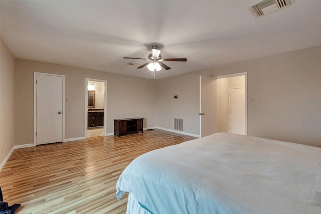 1327 Tiki Dr, Tiki Island, TX 77554 - bedroom featuring light wood-style floors, baseboards, ensuite bathroom, and a ceiling fan