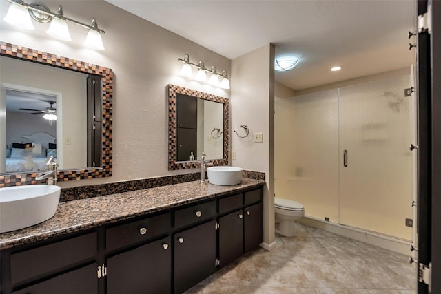 1327 Tiki Dr, Tiki Island, TX 77554 - full bath featuring a shower stall, double vanity, ensuite bathroom, ceiling fan, and tile patterned floors