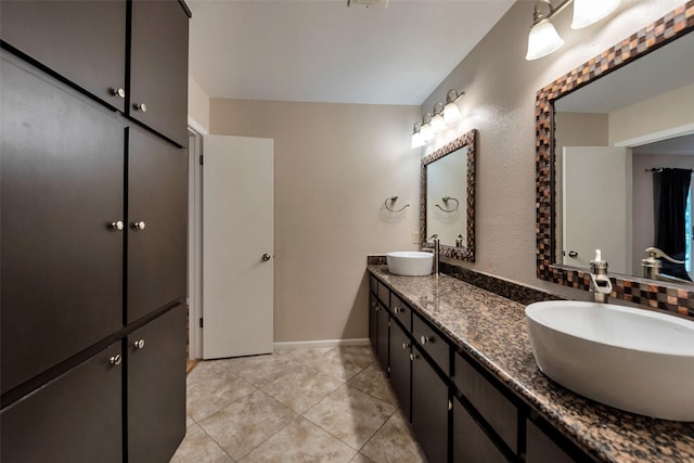 1327 Tiki Dr, Tiki Island, TX 77554 - bathroom with double vanity, tile patterned floors, and baseboards