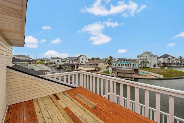 1327 Tiki Dr, Tiki Island, TX 77554 - wooden terrace with a residential view, a water view, and a boat dock