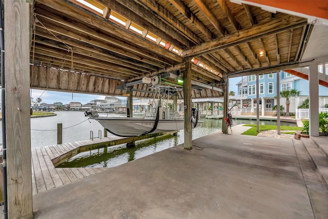 1327 Tiki Dr, Tiki Island, TX 77554 - dock area featuring a water view and boat lift