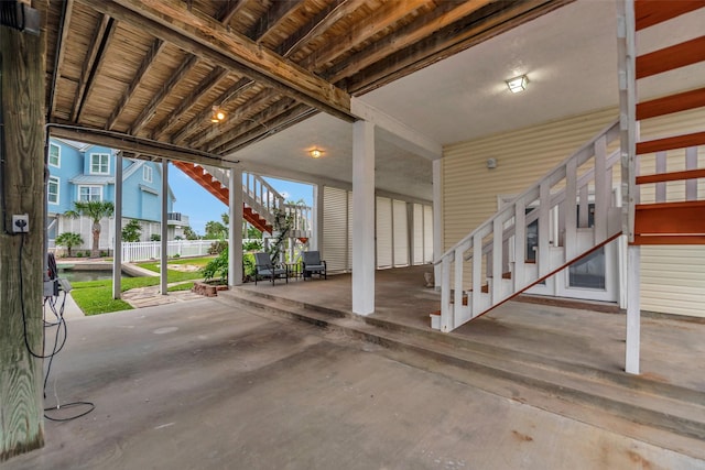 1327 Tiki Dr, Tiki Island, TX 77554 - view of patio / terrace with stairway and a carport