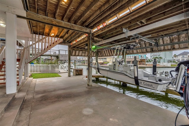 1327 Tiki Dr, Tiki Island, TX 77554 - dock area with boat lift, stairway, and a water view