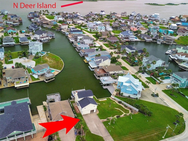 1327 Tiki Dr, Tiki Island, TX 77554 - aerial perspective of suburban area with a large body of water