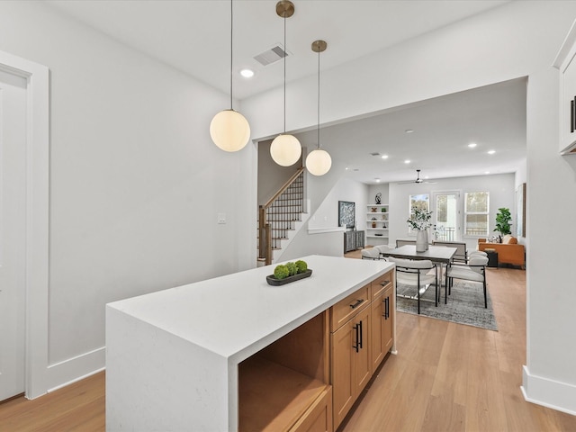 3516 Piney Woods Dr, Houston, TX 77018 - kitchen featuring light wood finished floors, pendant lighting, recessed lighting, a kitchen island, and light countertops