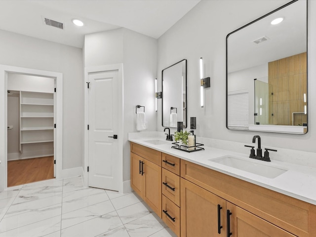 3516 Piney Woods Dr, Houston, TX 77018 - full bathroom featuring double vanity, a stall shower, marble finish flooring, a walk in closet, and baseboards