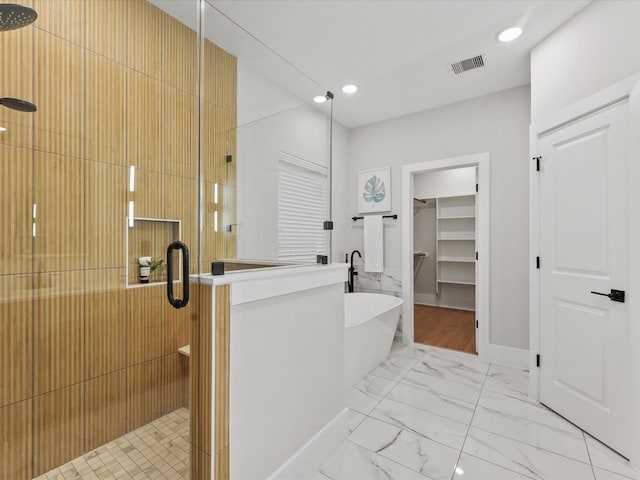 3516 Piney Woods Dr, Houston, TX 77018 - bathroom with a shower stall, a soaking tub, marble finish flooring, a walk in closet, and recessed lighting