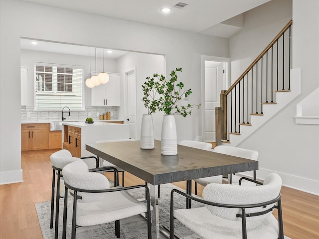 3516 Piney Woods Dr, Houston, TX 77018 - dining space featuring light wood-style flooring, recessed lighting, stairs, and baseboards