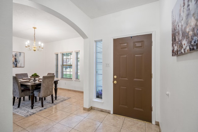 3102 Spring Flower Ln, Spring, TX 77388 - foyer featuring a chandelier, arched walkways, light tile patterned floors, and baseboards