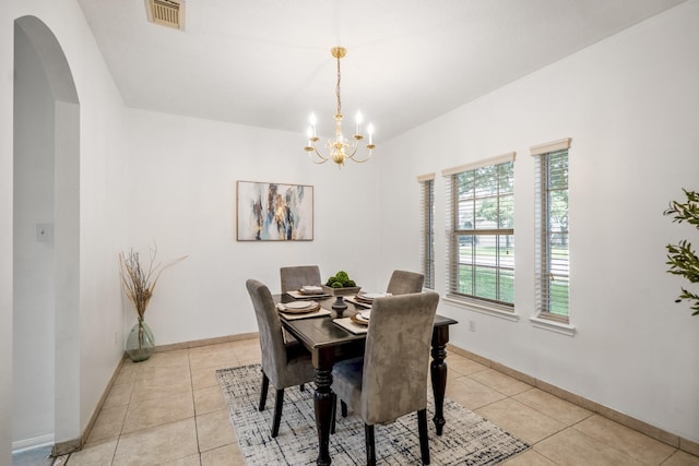 3102 Spring Flower Ln, Spring, TX 77388 - dining room with a chandelier, light tile patterned floors, arched walkways, and baseboards