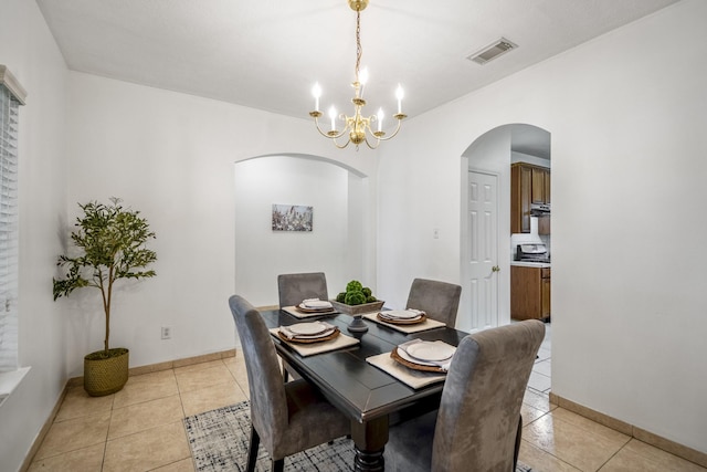 3102 Spring Flower Ln, Spring, TX 77388 - dining room featuring arched walkways, a chandelier, light tile patterned flooring, and baseboards