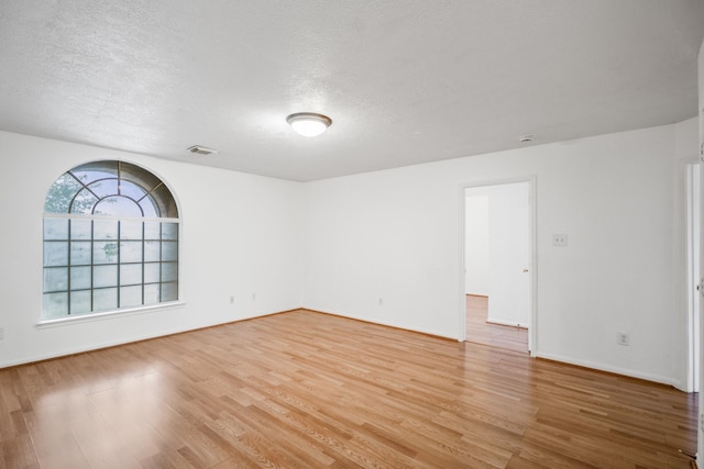3102 Spring Flower Ln, Spring, TX 77388 - spare room with light wood-style flooring, a textured ceiling, and baseboards