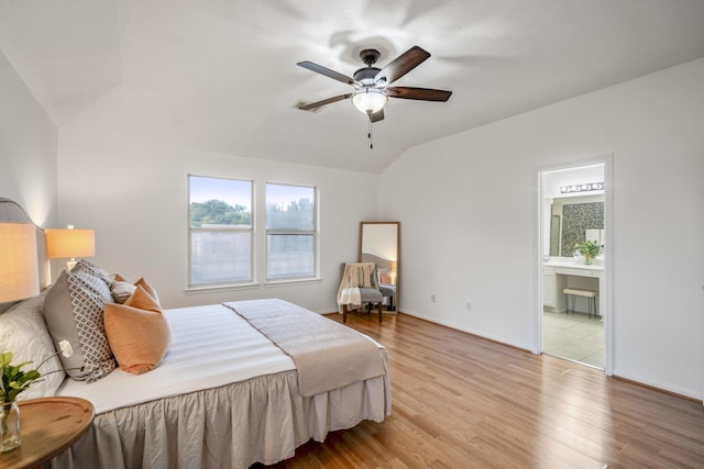 3102 Spring Flower Ln, Spring, TX 77388 - bedroom with multiple windows, lofted ceiling, light wood-style flooring, connected bathroom, and baseboards