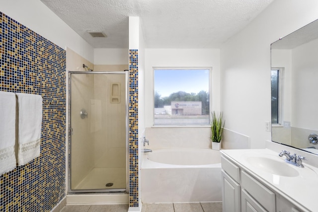 3102 Spring Flower Ln, Spring, TX 77388 - bathroom with a bath, a shower stall, vanity, a textured ceiling, and tile patterned flooring