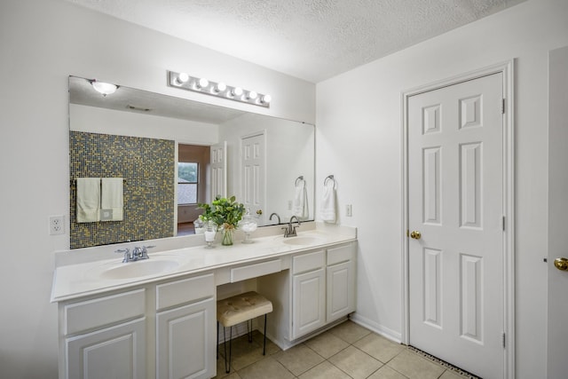 3102 Spring Flower Ln, Spring, TX 77388 - bathroom with tile patterned floors, double vanity, and a textured ceiling