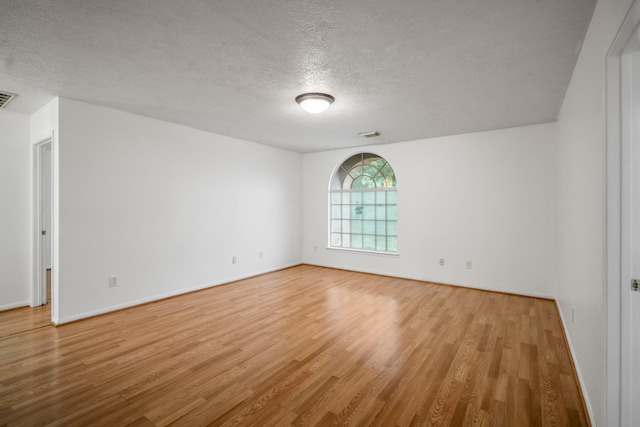 3102 Spring Flower Ln, Spring, TX 77388 - spare room featuring light wood-style flooring, a textured ceiling, and baseboards