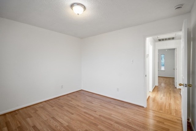 3102 Spring Flower Ln, Spring, TX 77388 - empty room featuring attic access, light wood-type flooring, baseboards, a smoke detector, and a textured ceiling