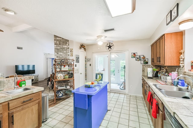 12206 Tawakom Dr, Tomball, TX 77375 - kitchen with a sink, ceiling fan, dishwashing machine, and brown cabinetry