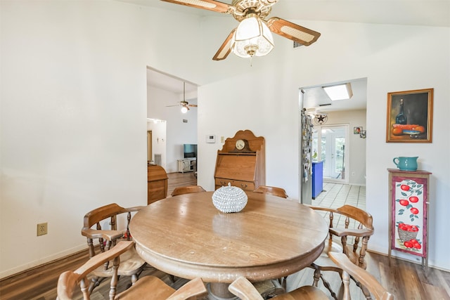 12206 Tawakom Dr, Tomball, TX 77375 - dining area with ceiling fan, a towering ceiling, wood finished floors, and baseboards