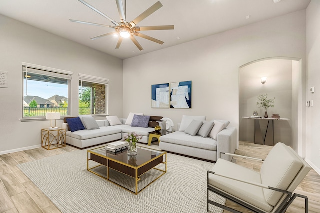 24743 Levante Dr, Richmond, TX 77406 - living area with arched walkways, wood finished floors, a ceiling fan, and baseboards