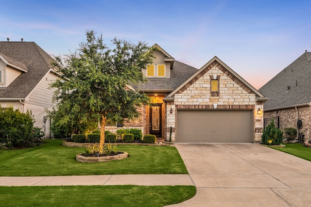 24743 Levante Dr, Richmond, TX 77406 - view of front of property featuring concrete driveway, a front yard, a garage, and stone siding