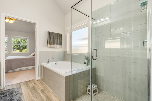 24743 Levante Dr, Richmond, TX 77406 - bathroom featuring wood finished floors, ensuite bathroom, a garden tub, lofted ceiling, and a stall shower